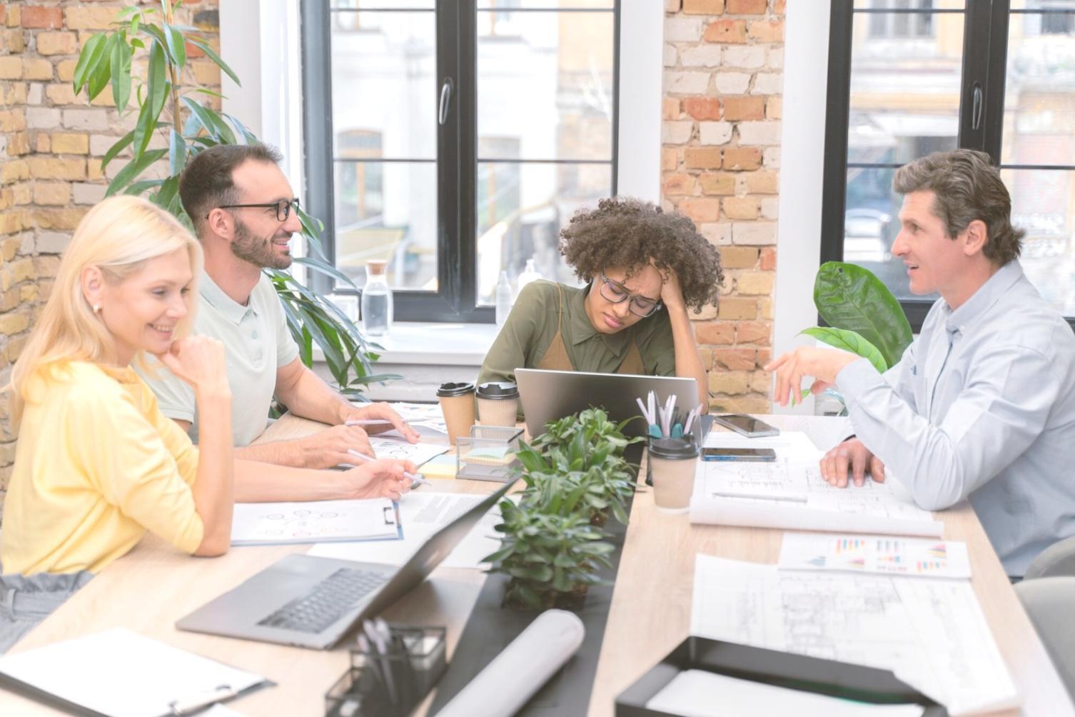 Students working collaboratively on financial analysis projects in modern learning environment